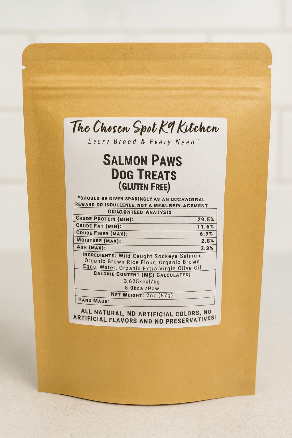 Package of Salmon Paws. Handmade organic dog treats from The Chosen Spot K9 Kitchen on a white background. Includes guaranteed analysis, ingredients and calorie content (ME) calculated.