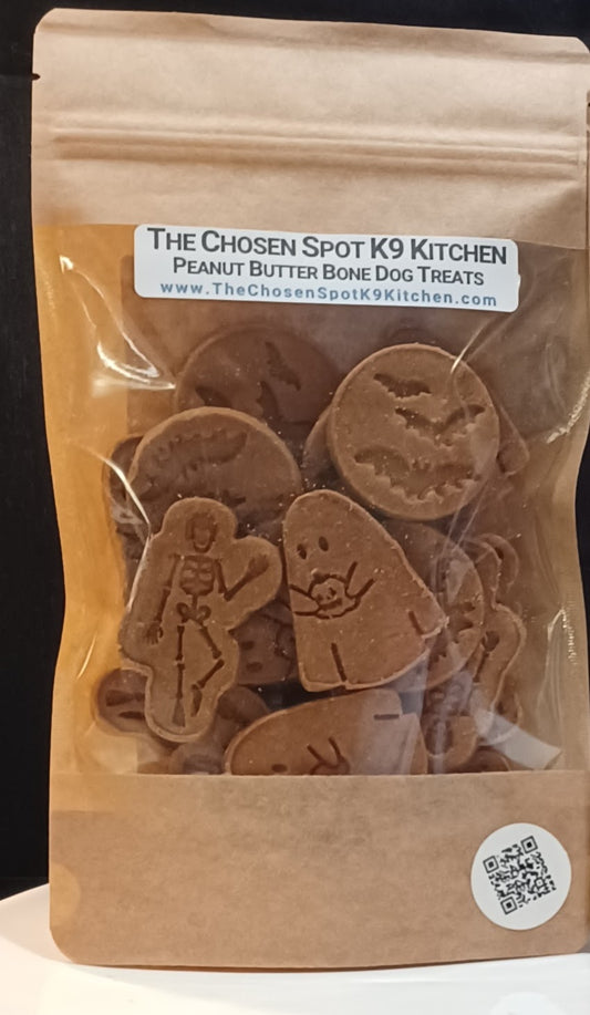 Package of The Chosen Spot K9 Kitchen Spooky Peanut Butter Bone dog treats with clear window on front of package where you can see the treats inside.
