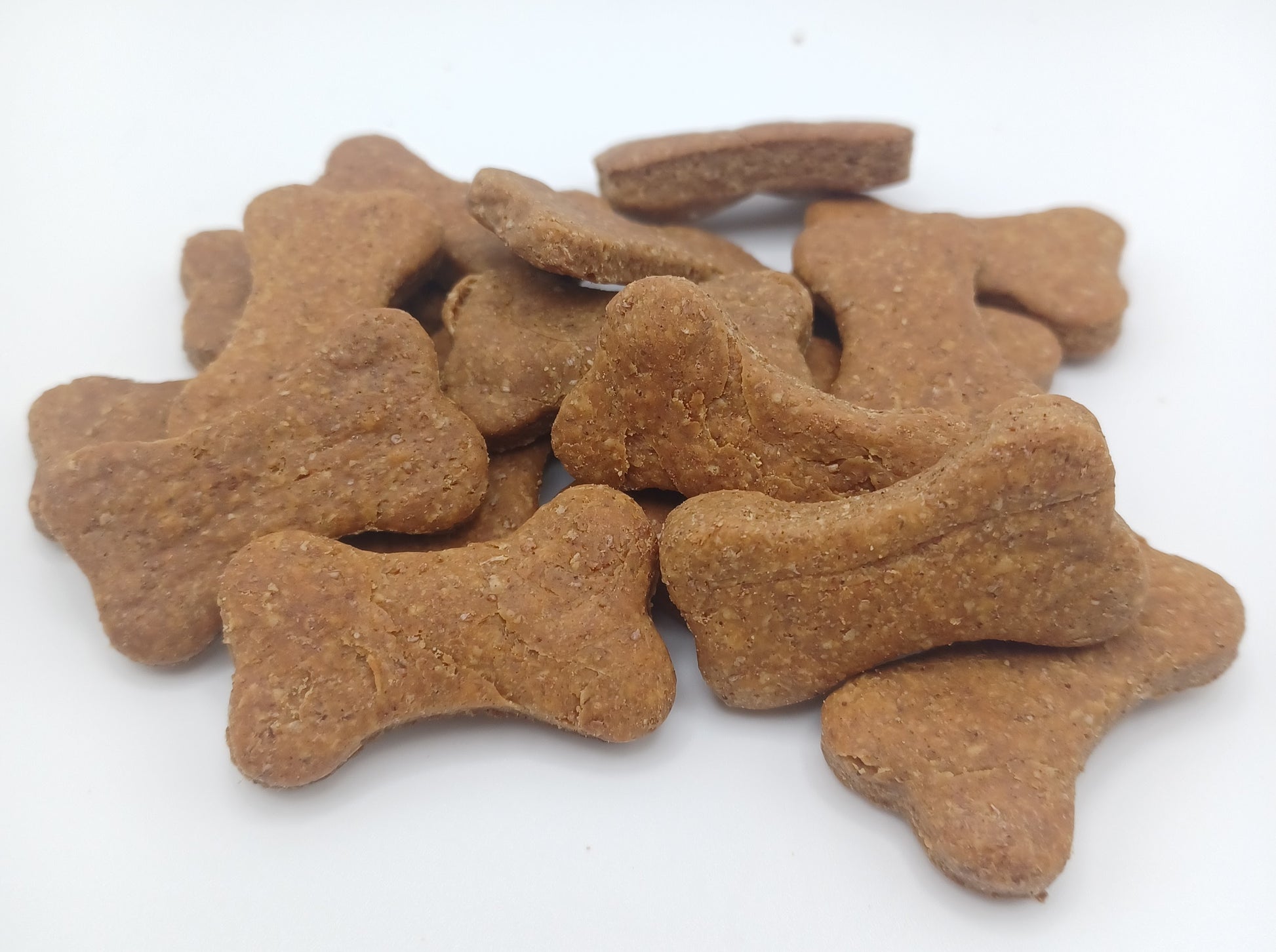 Peanut Butter Bones. Handmade organic dog treats from The Chosen Spot K9 Kitchen on a white background.